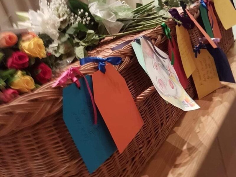 memory tags on a wicker coffin